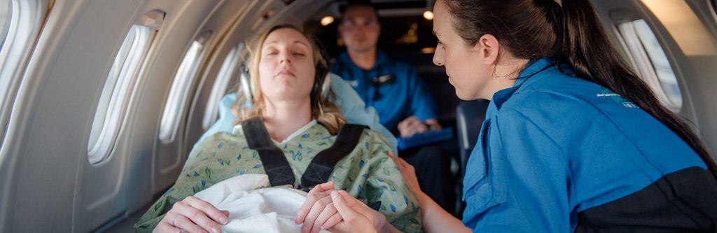 woman in air ambulance with headphones on