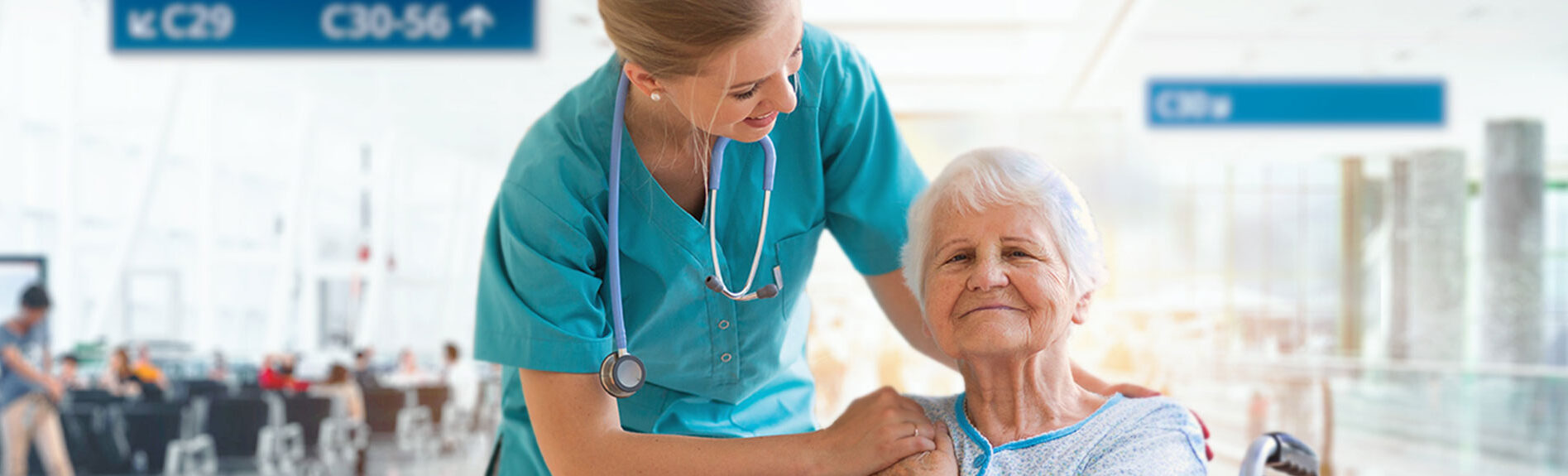 elderly woman smiling in airport with nurse