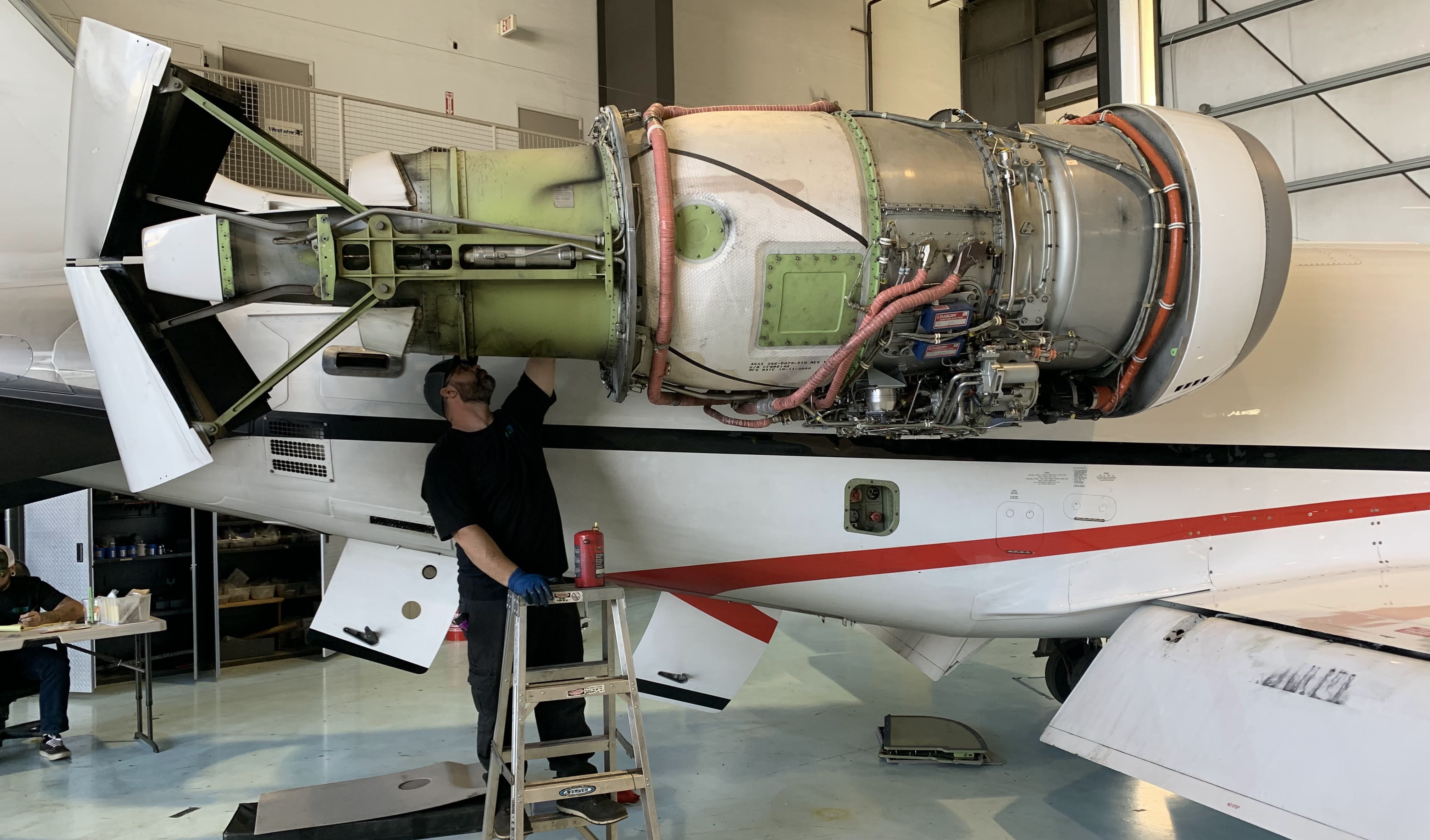 Learjet engine being worked on with cowling removed